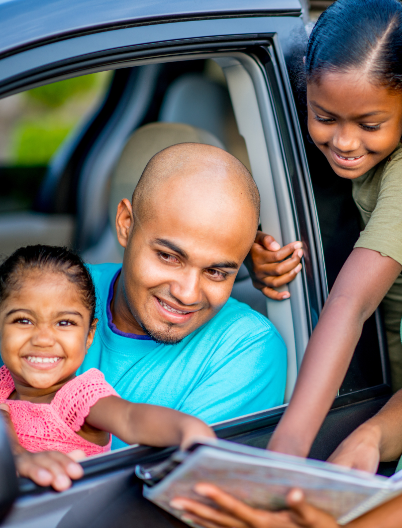 Happy family looking at options for vehicles