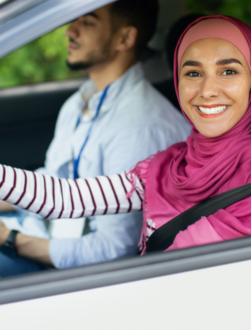 Lady in headscarf driving husband
