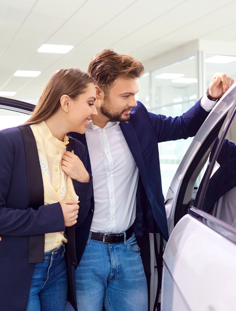 Young couple checking out new lease car