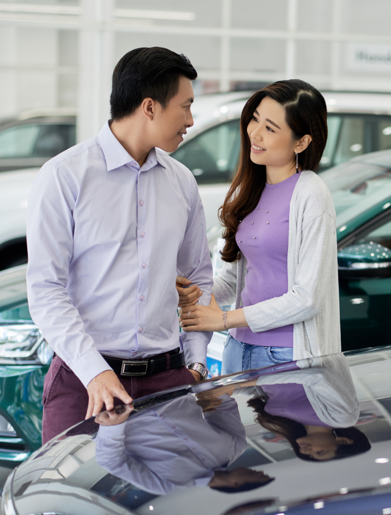 Asian couple deciding on car