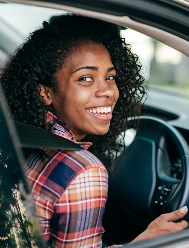 Smiling lady driving car