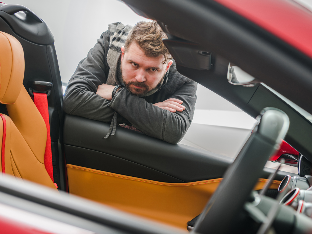 Man considering new luxury car