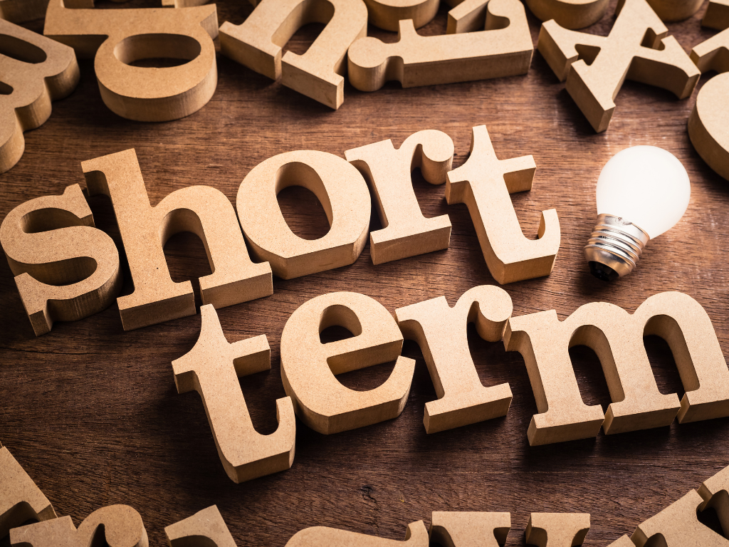Short term spelled out in wooden block letters